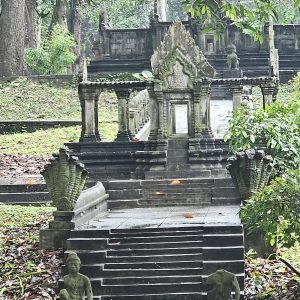A miniature Khmer sanctuary surrounded by trees
